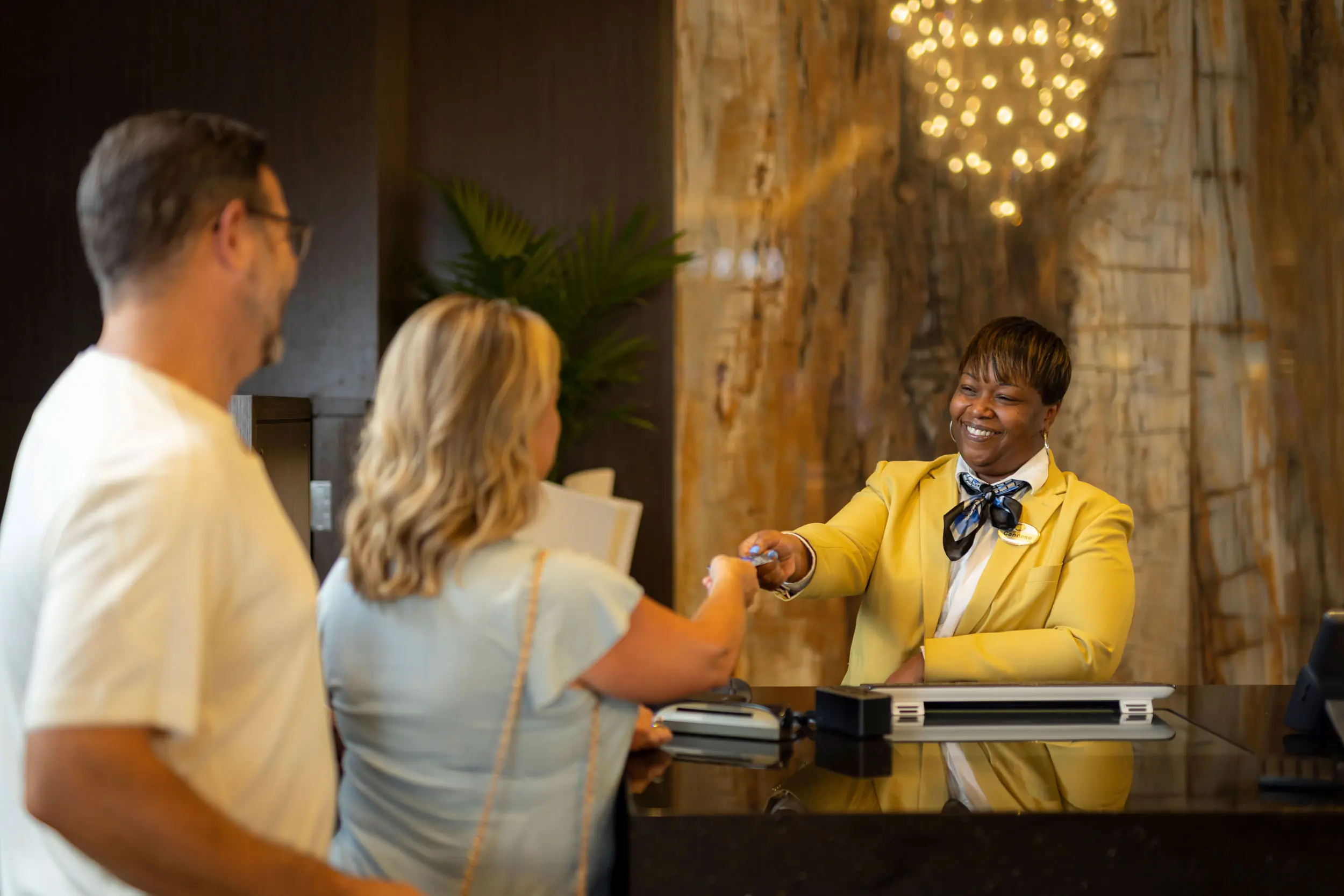 Person handing room key to guests at Southland Casino Hotel